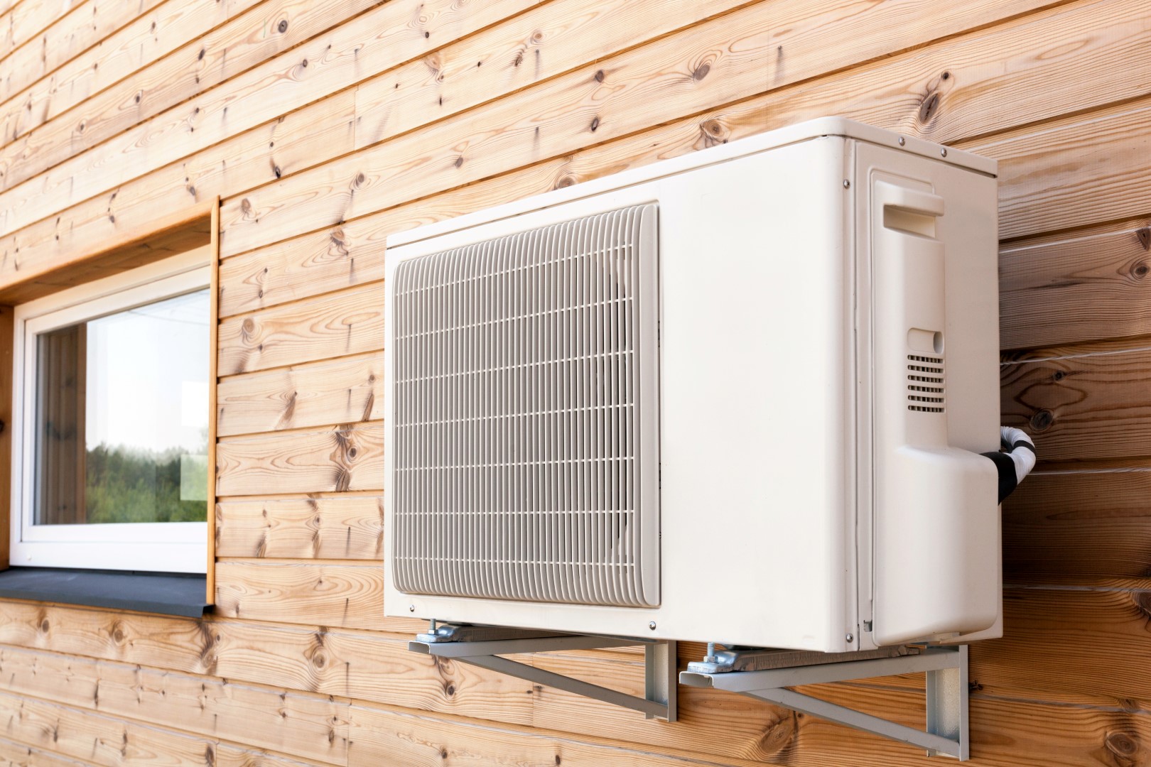 Exterior airconditioning unit on a wooden wall